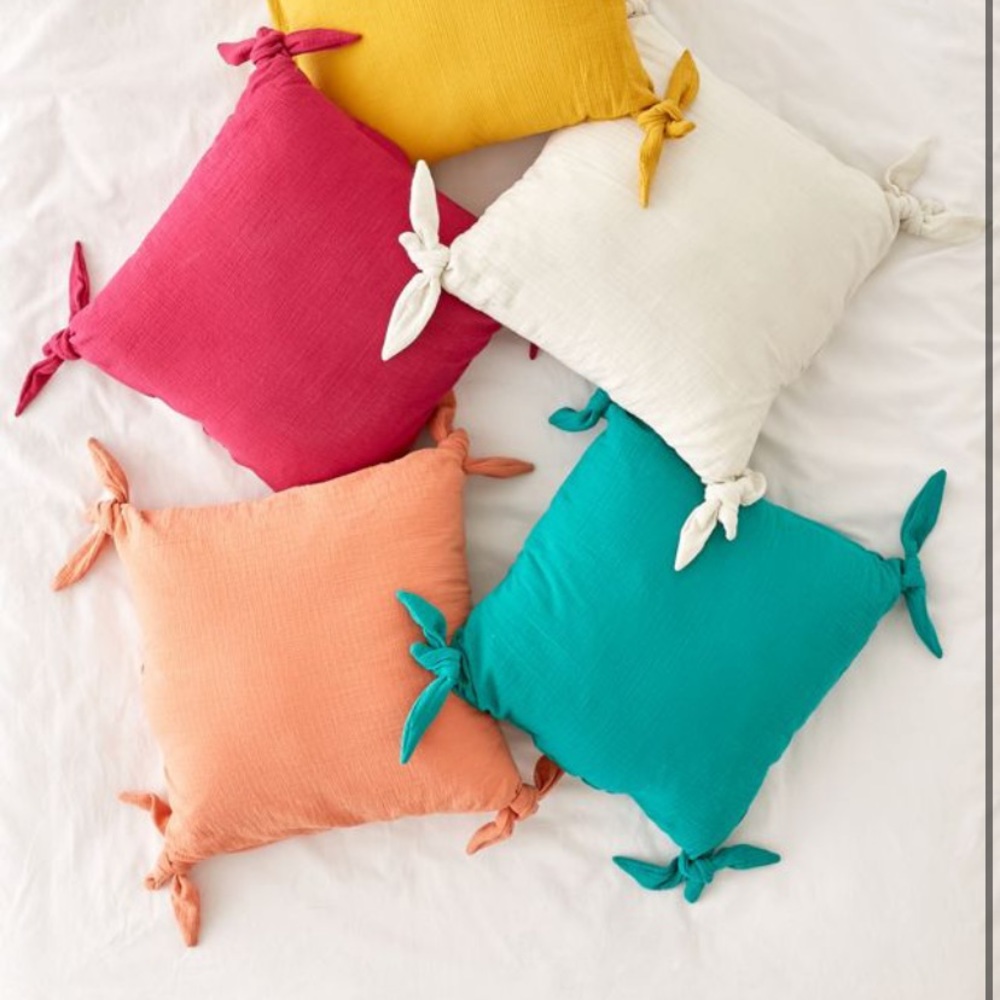 UO home raspberry tie pillow